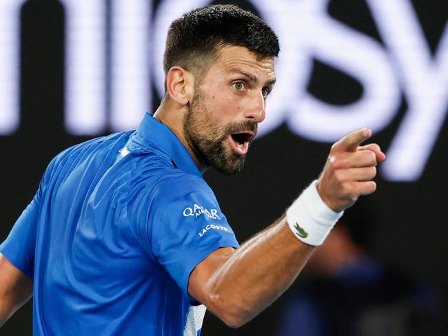 Serbia's Novak Djokovic reacts after a point against Czech Republic's Tomas Machac during their men's singles match on day six of the Australian Open tennis tournament in Melbourne on January 17, 2025. (Photo by Martin KEEP / AFP) / — IMAGE RESTRICTED TO EDITORIAL USE – STRICTLY NO COMMERCIAL USE —