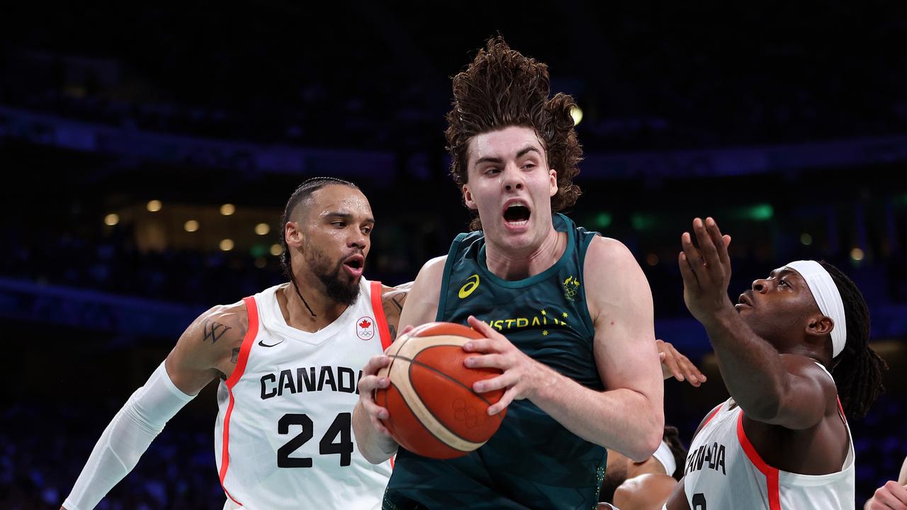 LILLE, FRANCE - JULY 30: Josh Giddey #3 of Team Australia grabs the rebound from Luguentz Dort #0 of Team Canada during the Men's Group Phase - Group A match between Team Canada and Team Australia on day four of the Olympic Games Paris 2024 at Stade Pierre Mauroy on July 30, 2024 in Lille, France. (Photo by Gregory Shamus/Getty Images)