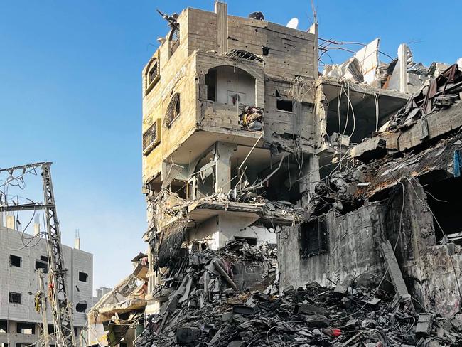 A Palestinian girl inspects the rubble of a building after an Israeli strike in Beit Lahia, in the northern Gaza Strip, on October 29, 2024, amid the ongoing war in the Palestinian territory between Israel and Hamas. Gaza's civil defence agency said on October 29, that an overnight Israeli air strike killed more than 55 people in a residential building in the northern district of Beit Lahia. (Photo by AFP)