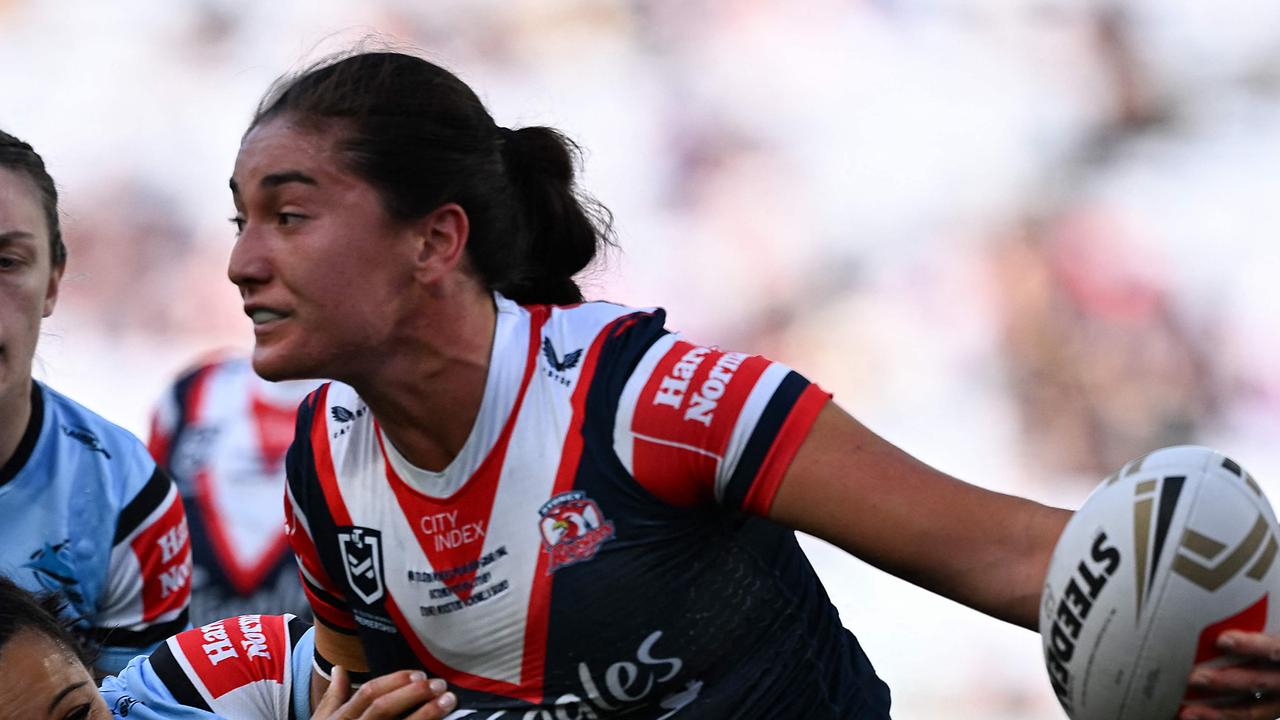 Sydney Roosters' Olivia Kernick (R) is tackled during the National Rugby League (NRL) Women's Grand Final match between Sydney Roosters and Cronulla Sharks at Accor Stadium in Sydney on October 6, 2024. (Photo by Izhar KHAN / AFP) / -- IMAGE RESTRICTED TO EDITORIAL USE - STRICTLY NO COMMERCIAL USE --