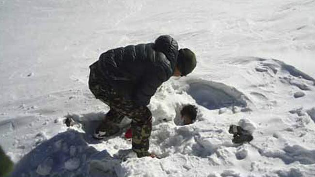 A Nepalese army soldier searches for avalanche victims at Thorong La pass area in Nepal on Sunday. (AP Photo/Nepalese Army)