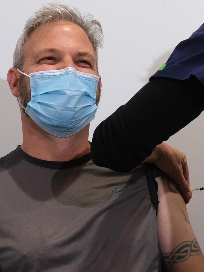 Brett Sutton laughs as he receives his first AstraZeneca jab. Picture: Getty Images