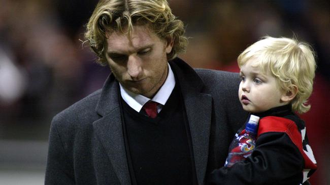 James Hird with son Tom during the Bomber great’s playing days. Pic: Kelly Barnes 