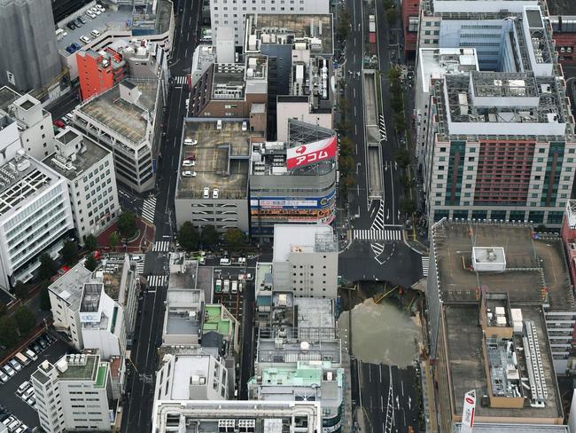 A massive sinkhole is created in the middle of the business district in Fukuoka, southern Japan. Picture: AP