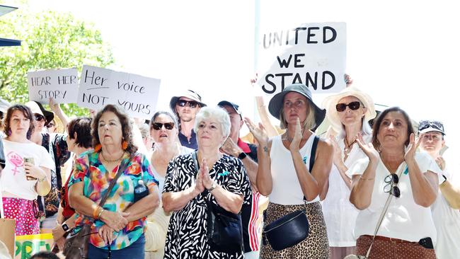 Crowd members held placards. Picture: Brendan Radke