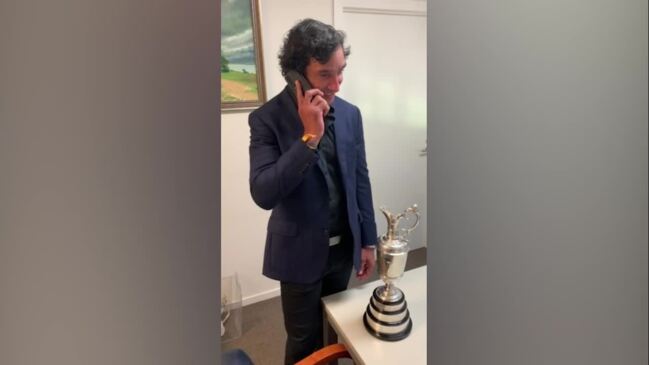 Johnathan Thurston chugs a beer from the Claret Jug