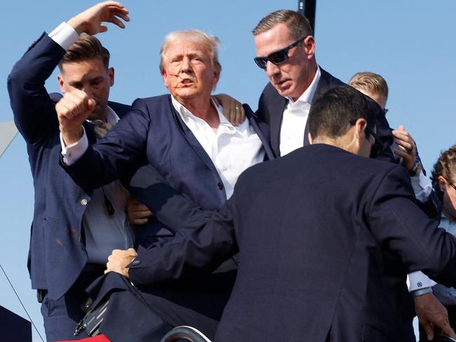 BUTLER, PENNSYLVANIA - JULY 13: Republican presidential candidate former President Donald Trump is rushed offstage during a rally on July 13, 2024 in Butler, Pennsylvania.   Anna Moneymaker/Getty Images/AFP (Photo by Anna Moneymaker / GETTY IMAGES NORTH AMERICA / Getty Images via AFP)