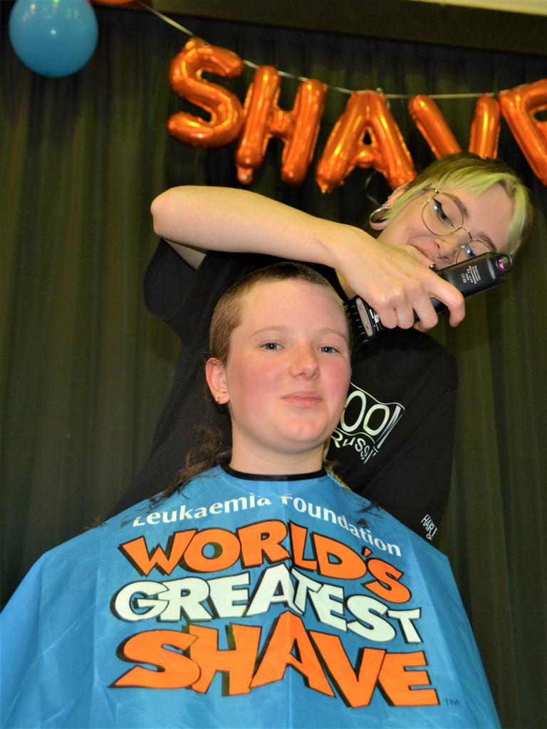 At the St Joseph's College 2023 World's Greatest Shave event is Meghan Ellis getting her cut by hairdresser Caitlin Symes from the Hair Room on Russell. Picture: Rhylea Millar