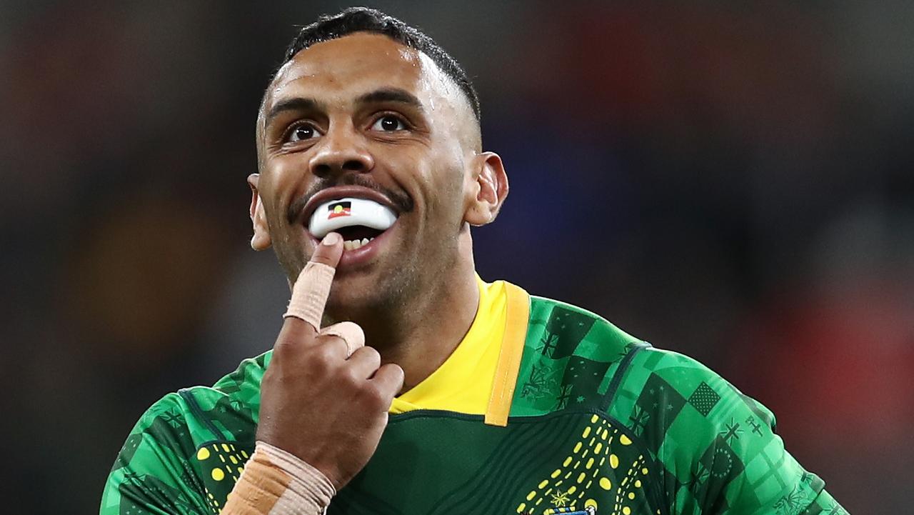 Josh Addo-Carr of Australia gestures towards his mouth-guard after scoring a try.