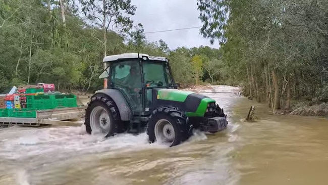 My Fruit Shop use a tractor to haul fresh produce across a creek that has blocked the farm off for nearly an entire week.