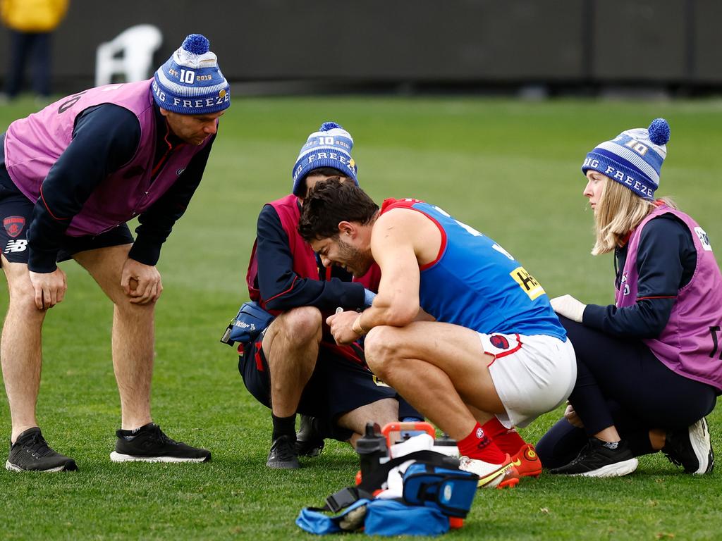 Christian Petracca speaks to staff after a collision on King’s Birthday. Picture: Michael Willson/AFL Photos via Getty Images.