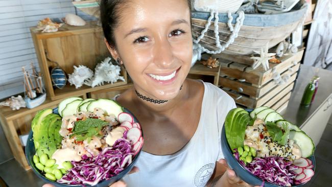 Sandbar waitress Larissa Mallet with a selection of poke bowls. Picture: Mike Batterham