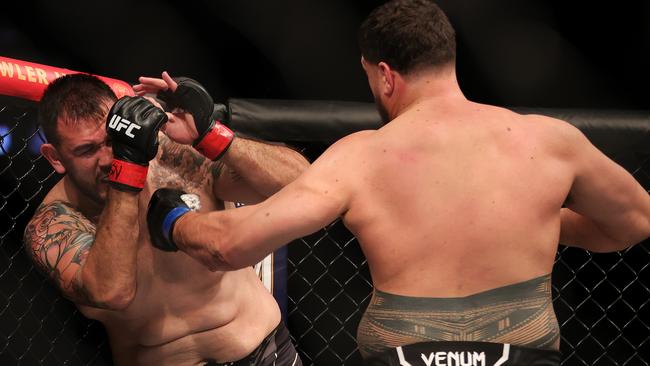 Tai Tuivasa (right) launches a barrage of punches on his Brazilian opponent.