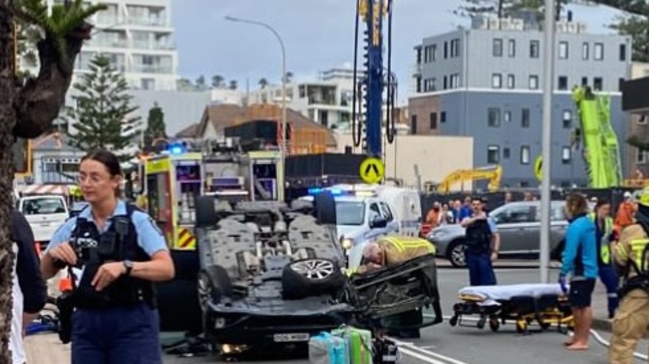 Emergency services rushed to the intersection near Wentworth St and South Steyne Rd near Manly Beach to free a man from his flipped car. Picture: Manly Observer