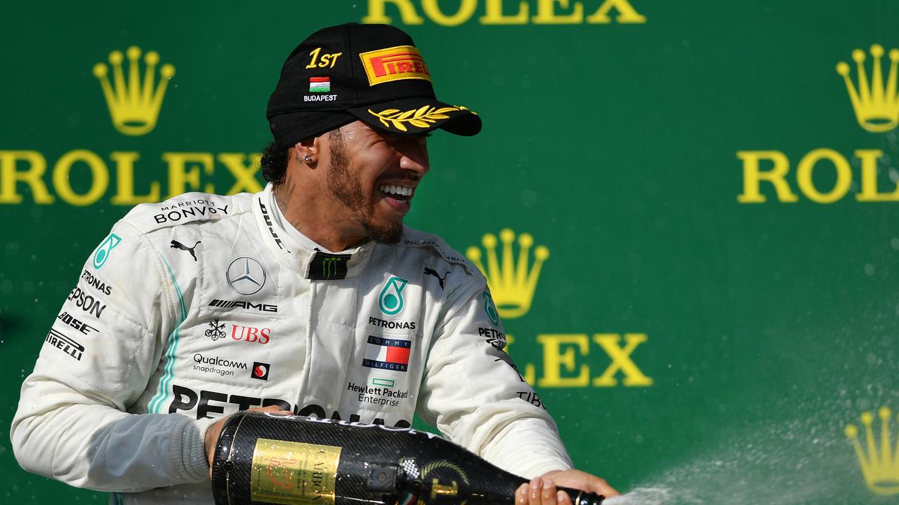 Lewis Hamilton celebrates on the podium in Hungary.