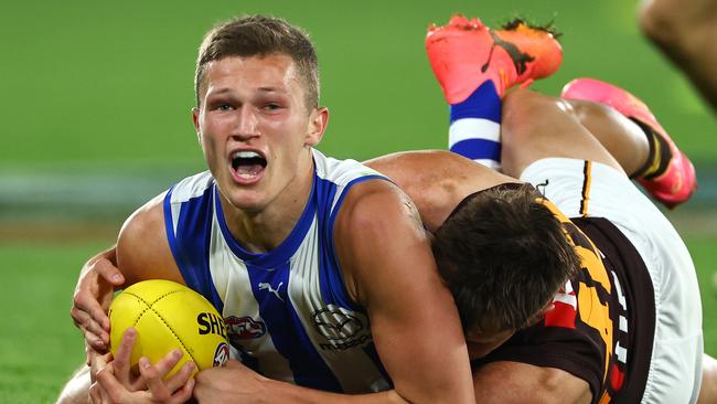 MELBOURNE, AUSTRALIA - APRIL 21: Zane Duursma of the Kangaroos attempts to handballs whilst being tackled during the round six AFL match between North Melbourne Kangaroos and Hawthorn Hawks at Marvel Stadium, on April 21, 2024, in Melbourne, Australia. (Photo by Quinn Rooney/Getty Images)