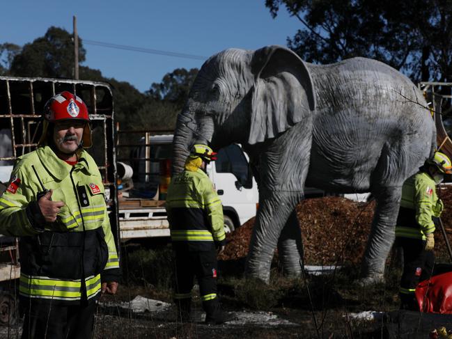 Firefighters survey the site on Thursday, following the previous day’s fire. Picture: Jane Dempster