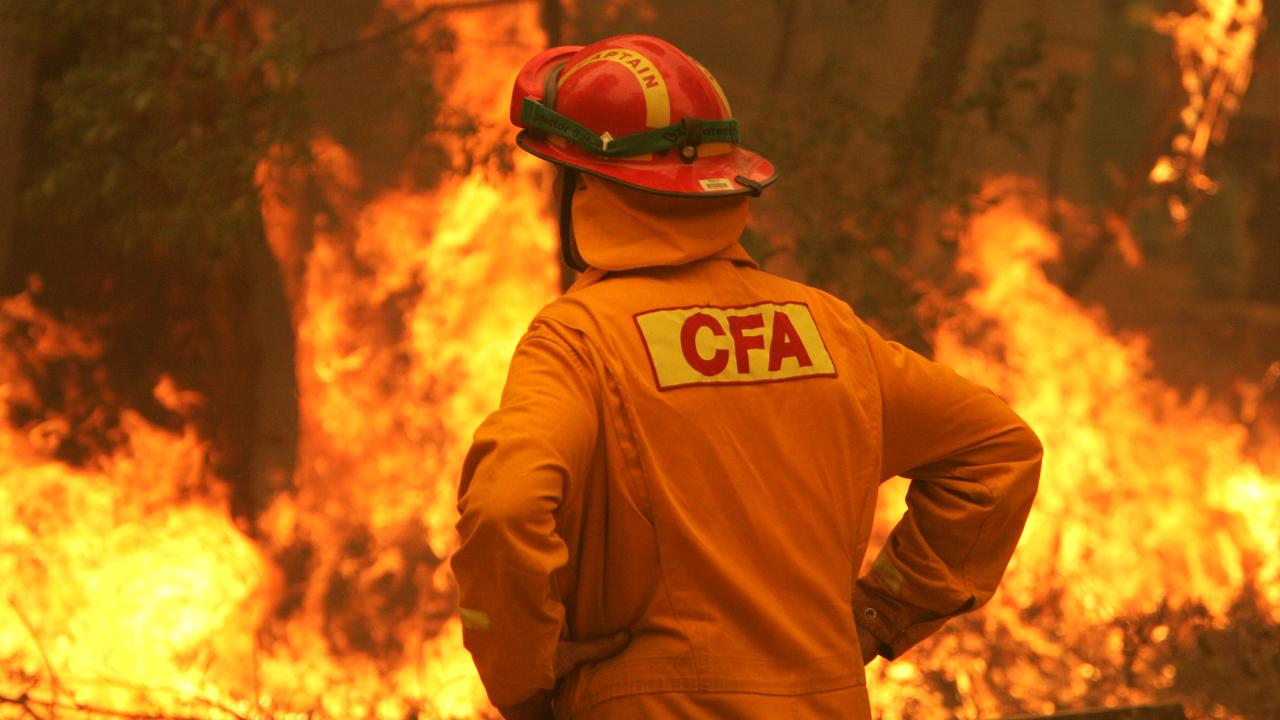 CFA and DSE firefighters work to control the fire as it sweeps through woodland on the Jamieson- Woods Point Road, south of Jamieson, in northeastern Victoria.