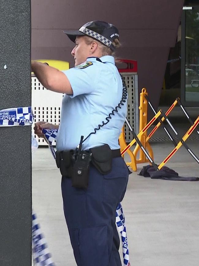 A jumper is seen on the ground as police tape off the scene. Picture: TNV