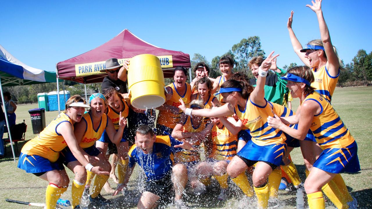 WINNERS: Gympie Veteran womens hockey coach Dave Dixon gets showered in ice water after his team won Division 5 at the state titles in Rockhampton. Photo Craig Warhurst/The Gympie Times