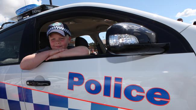 Hayden Vigors, 8, from Casula enjoyed sitting in a highway patrol car. Photos: Robert Pozo