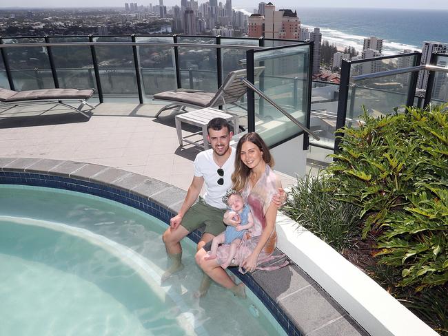 Jason Papillo and Vanessa Papillo with 3 month old baby Ivy Papillo by the pool on the roof of Wave Broadbeach overlooking the Gold Coast for a story previewing the holidays. Picture: Richard Gosling