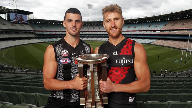 Collingwood’s Scott Pendlebury and Essendon’s Dyson Heppell show off the strips for the Anzac Day clash at the MCG. Picture: Dylan Burns/AFL Photos via Getty Images