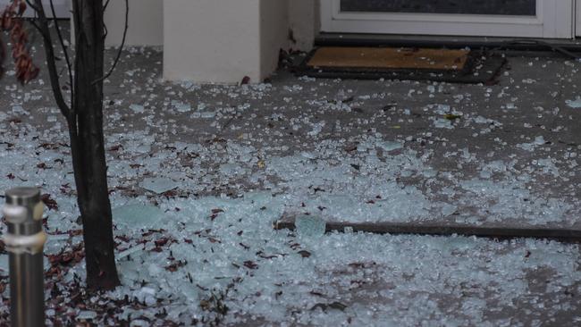 Shattered glass litters the ground after shots were fired at a home in Elinor Tce, Glen Osmond overnight Picture: RoyVPhotography