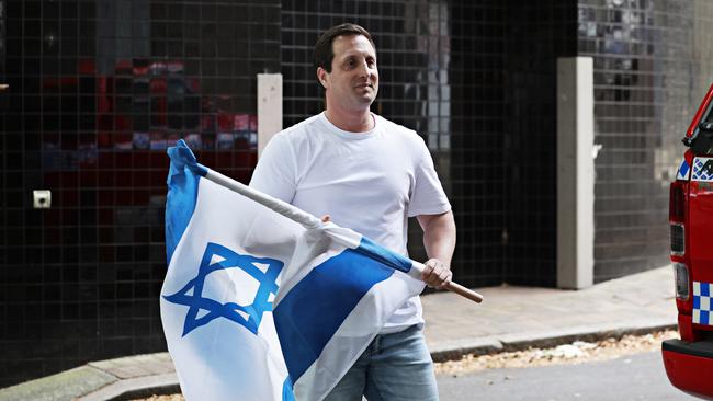 Mark Spiro was arrested “for his own safety” for holding an Israeli flag near a pro-Palestine rally that moved from Sydney Town Hall to the Opera House. Picture: Adam Yip