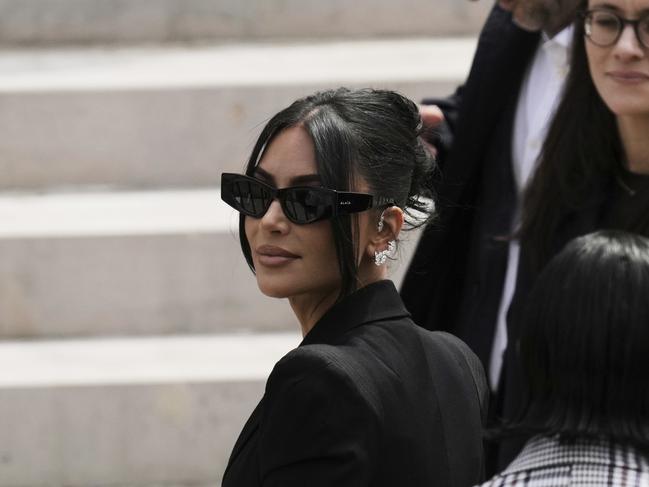 Kim Kardashian, left, arrives to testify regarding a robbery of millions of dollars in jewels from her Paris hotel room in 2016, in Paris, Tuesday, May 13, 2025. (AP Photo/Aurelien Morissard)