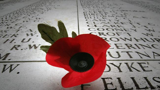 Honour them ... a poppy is left on a wall displaying the names of the missing on the Menin Gate Memorial, in Ypres, Belgium. Picture: Matt Cardy/Getty Images