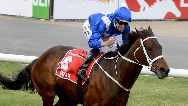 Hugh Bowman rides Winx to a fourth Cox Plate. Picture: Jay Town