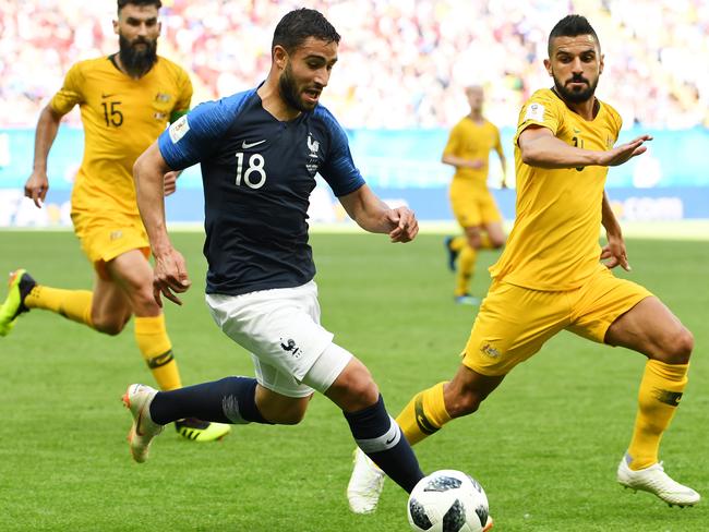 France’s Nabil Fekir feels the pressure from Socceroos Mile Jedinak and Aziz Behich at Kazan Arena on Saturday. Picture: AAP