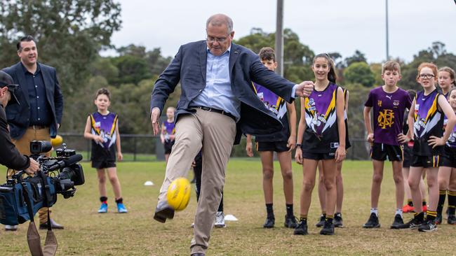 Mr Morrison puts the boot in while visiting Norwood Sporting Club in Ringwood Victoria. Picture: Jason Edwards