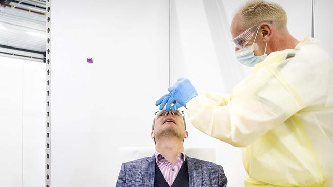 The last Covid test is taken from a person in a Covid testing centre in Tiel, on March 17, 2023 before it closes. - Now that large-scale testing for Covid is no longer deemed to have added value, the Public Health service test lanes are closing. (Photo by Koen van Weel / ANP / AFP) / Netherlands OUT - Belgium OUT