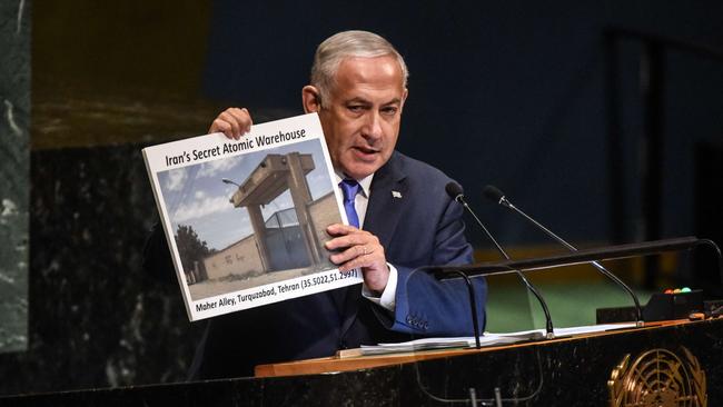 Benjamin Netanyahu holds up a placard of a suspected Iranian atomic site while delivering a speech at the United Nations in 2018. Picture: Getty Images