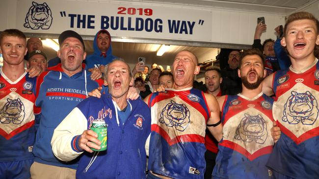 NFNL: Shane Harvey and his father Neil sing the song after North Heidelberg’s win. Picture: Hamish Blair