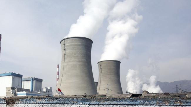 DATONG COUNTY, CHINA - JANUARY 31: (CHINA OUT) A farmer leads a cart walking past cooling towers of the coal-fired Datong County Thermal Power Plant on January 31, 2007 in Datong County of Qinghai Province, China. China has failed to make any headway with its efforts to protect the environment over the last three years as compared with other nations. A new government report ranks the country 100th on a list of 118 developing and developed countries in terms of "ecological modernization", the same ranking it held in 2004, according to the Modernization Report 2007 released by the Chinese Academy of Science. (Photo by China Photos/Getty Images)