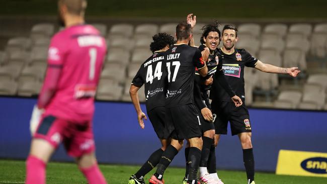 Kosta Petratos celebrates with his teammates after scoring the late winner.