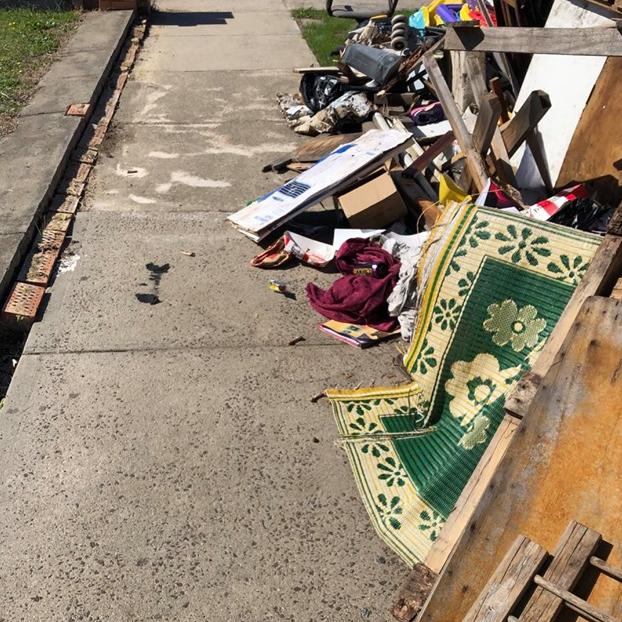 Rubbish strewn across the Darebin Drive footpath.