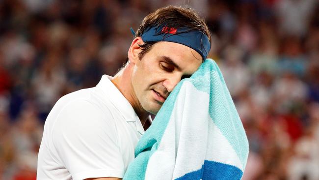 Switzerland's Roger Federer rests during a break in his men's singles match.