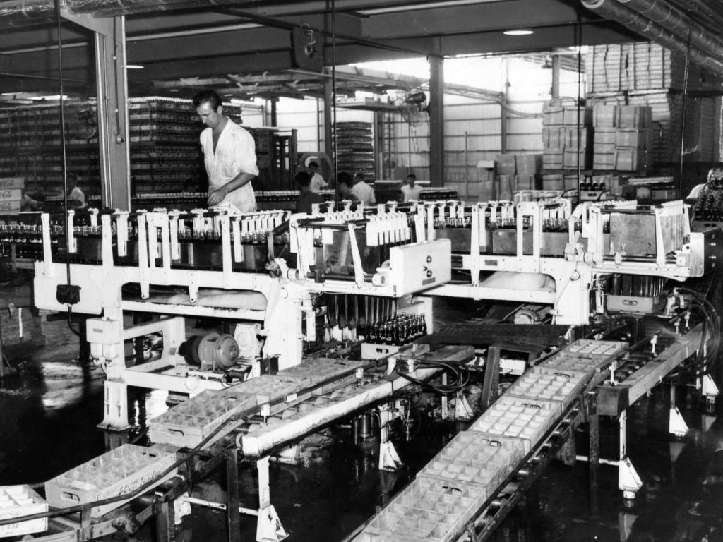 Modern machinery recently installed at Coca-Cola Bottlers (Adelaide) Ltd. bottling plant in Port Road, Thebarton. It could produce half a million bottles of Coca-Cola in a 12-hour working day. It was the only machinery of its type to be installed in any plant in Australia, September 1, 1960. Picture: Pency Jones