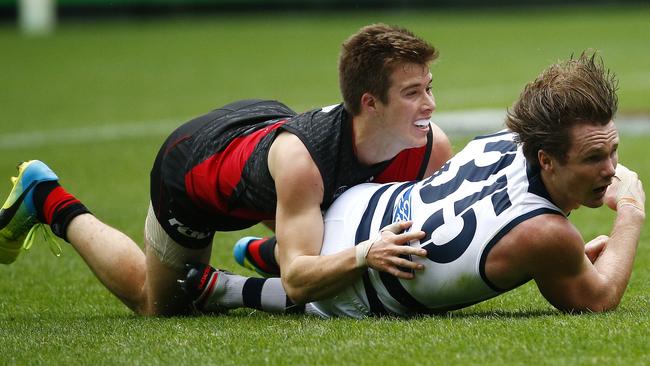 Essendon's Zach Merrett makes a great tackle on Patrick Dangerfield. Picture: Colleen Petch