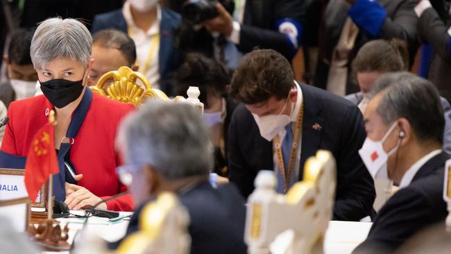 Foreign Minister Penny Wong looks towards her Chinese counterpart Wang Yi at the East Asia Summit in Phnom Penh on Friday. Picture: DFAT / Michael Godfrey