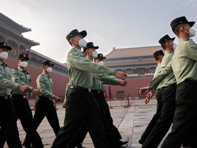 (FILES) In this file photo taken on May 21, 2020 People's Liberation Army (PLA) soldiers march next to the entrance to the Forbidden City during the opening ceremony of the Chinese People's Political Consultative Conference (CPPCC) in Beijing. - The Chinese military is pressing to double its 200-plus nuclear warheads within a decade with the ability to launch them aboard ballistic missiles by land, sea and air, the Pentagon said in a report September 1, 2020. (Photo by NICOLAS ASFOURI / AFP)