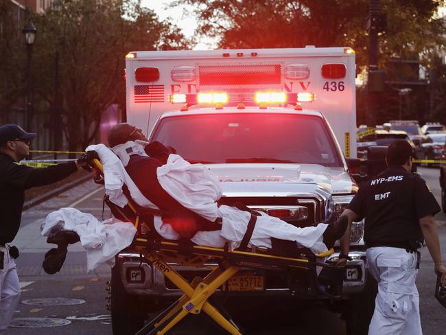 Emergency personnel transport a man on a stretcher after a motorist drove onto a busy bicycle path near the World Trade Centre memorial and struck several people. Picture: AP