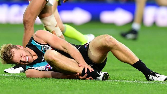 Port Adelaide’s Jack Watts grabs his ankle after his final term injury. Picture: Mark Brake/Getty Images