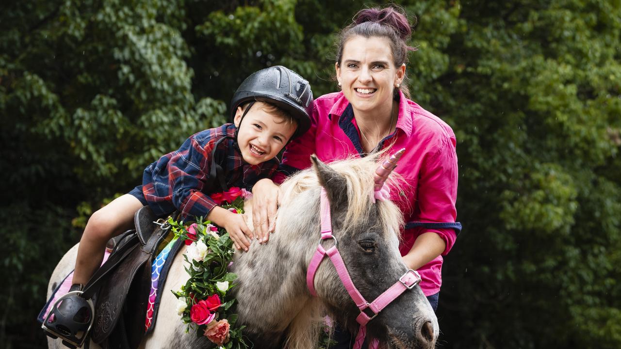 Pony Parties Toowoomba owner Lauren Sykes takes her son Josiah Sykes for a pony ride on Cookie. Picture: Kevin Farmer