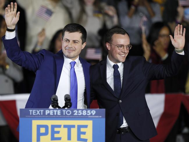 Pete Buttigieg and husband Chasten wave to supporters at a caucus night campaign rally, Monday, February 3, 2020, in Des Moines, Iowa. Picture: AP Photo/Charlie Neibergall