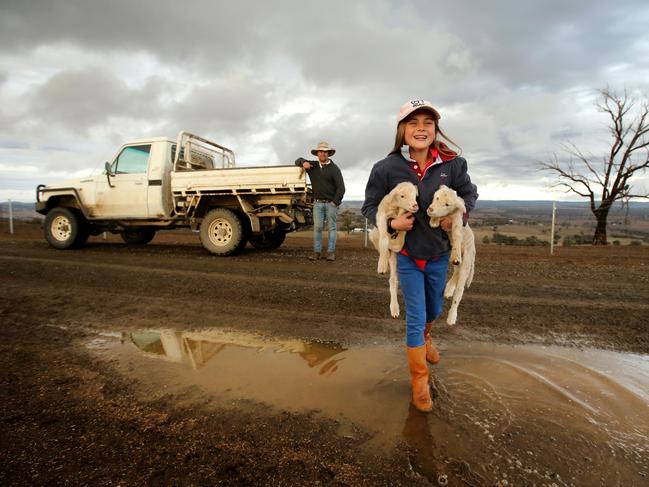 Walcha has also been hit hard by the drought. Farmer Jock McLaren with his 11 year old daughter Mimi welcome a drop of rain on their drought stricken property between Walcha and Tamworth last year. Picture: Nathan Edwards